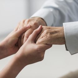 nurse-holding-senior-man-s-hands-sympathy